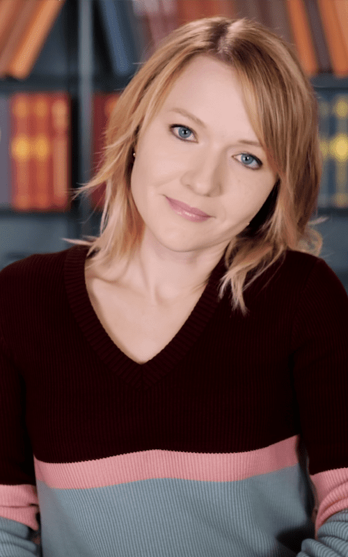 Michelle M. Pillow, NYT and USA Today Bestselling Fiction Author Michelle M. Pillow headshot with bookshelf background, NYT bestselling romantasy author